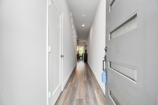 corridor with light hardwood / wood-style floors