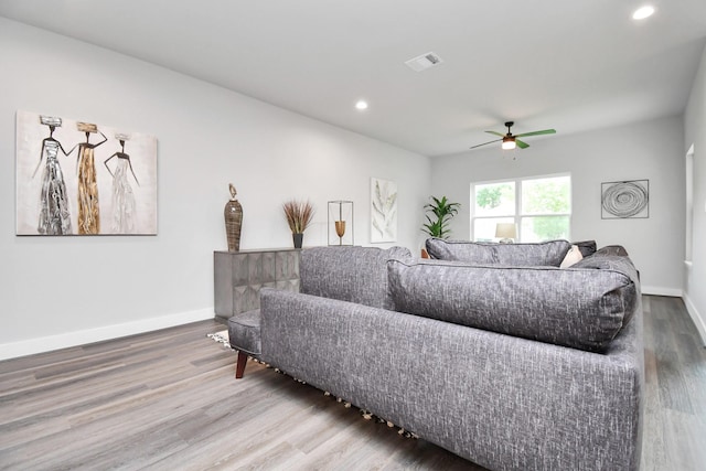 living room with hardwood / wood-style flooring and ceiling fan