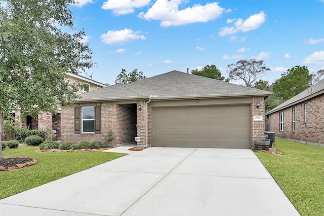 single story home with a garage, concrete driveway, brick siding, and a front yard