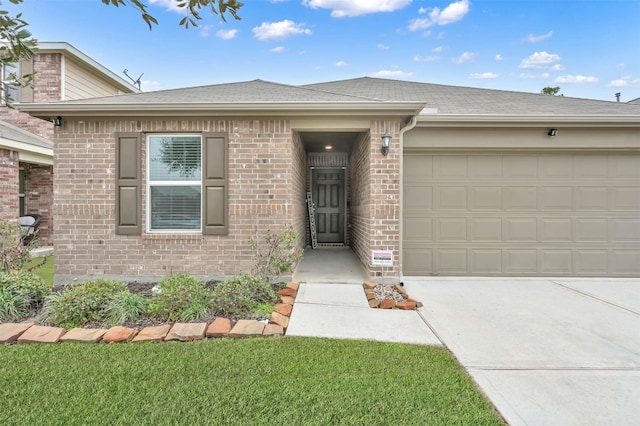 view of front facade featuring driveway, brick siding, an attached garage, and a shingled roof