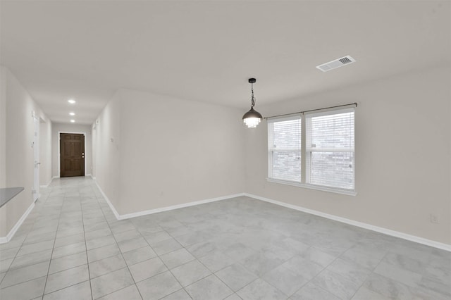 spare room featuring light tile patterned floors, recessed lighting, visible vents, and baseboards