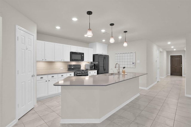 kitchen featuring black appliances, backsplash, a sink, and white cabinetry