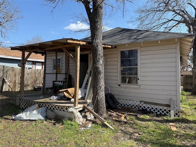 rear view of house featuring a wooden deck