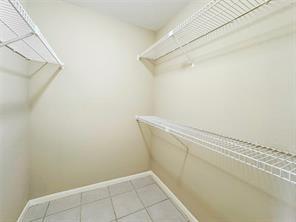 spacious closet with light tile patterned flooring