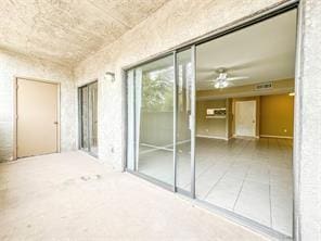 empty room with tile patterned floors and ceiling fan