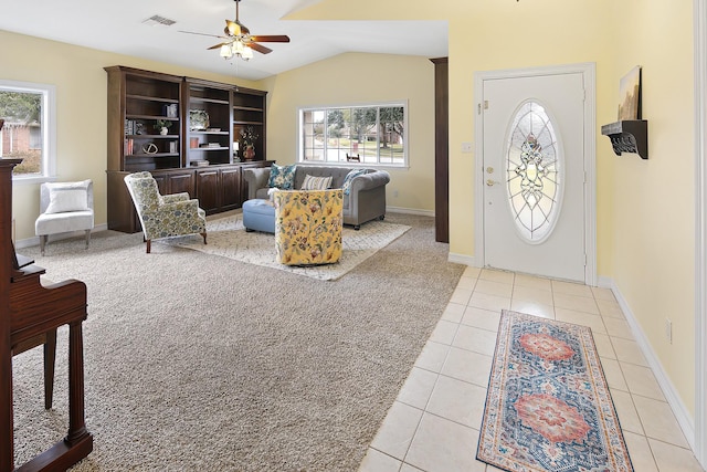 foyer entrance featuring lofted ceiling, light tile patterned floors, and ceiling fan