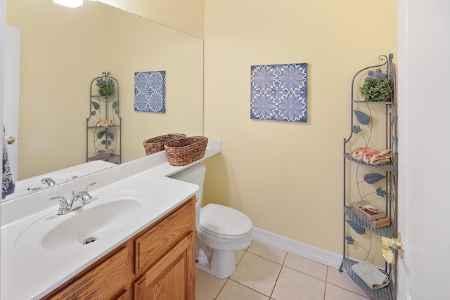 bathroom with vanity, toilet, and tile patterned flooring