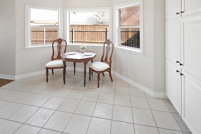 dining area featuring light tile patterned flooring and a wealth of natural light