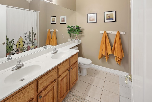 bathroom with vanity, tile patterned floors, and toilet