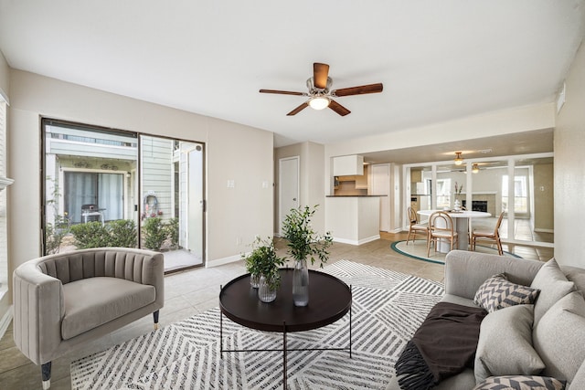 tiled living room featuring ceiling fan and a fireplace