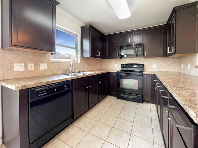 kitchen featuring tasteful backsplash, sink, light tile patterned floors, black appliances, and crown molding