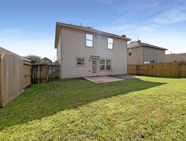 rear view of house featuring a yard and a patio area