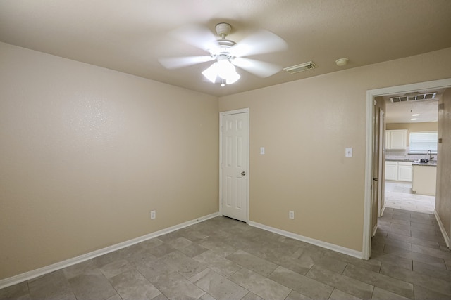 unfurnished room with ceiling fan