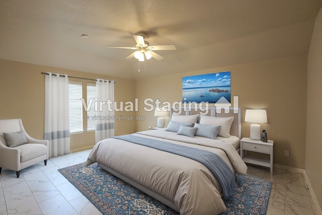 bedroom with ceiling fan and a textured ceiling