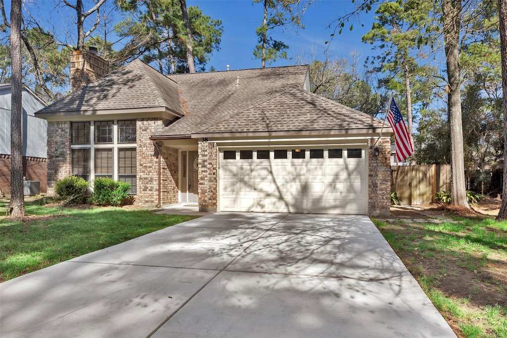 view of front of house with a front yard and a garage