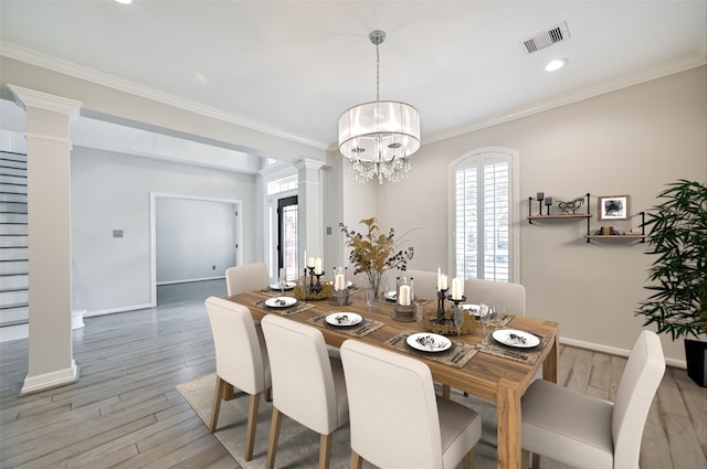 dining space featuring ornamental molding, wood finished floors, decorative columns, and visible vents