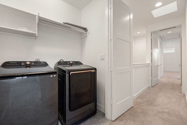 laundry area featuring light colored carpet and washer and clothes dryer