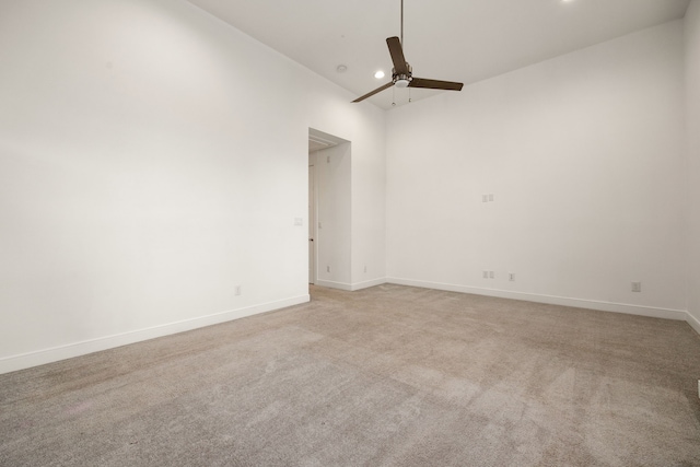 carpeted spare room with ceiling fan