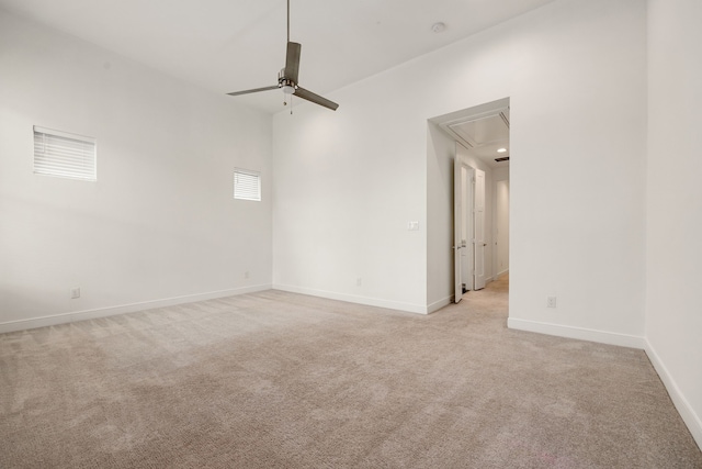 unfurnished room featuring light carpet and ceiling fan