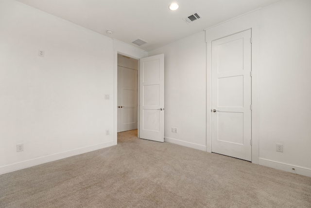 unfurnished bedroom featuring light carpet