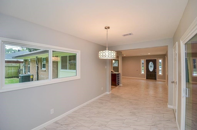 corridor featuring marble finish floor, visible vents, and baseboards