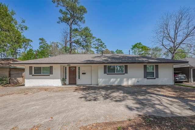 4822 Ella Blvd, Houston, TX 77018 - ranch-style home with brick siding, driveway, and a shingled roof