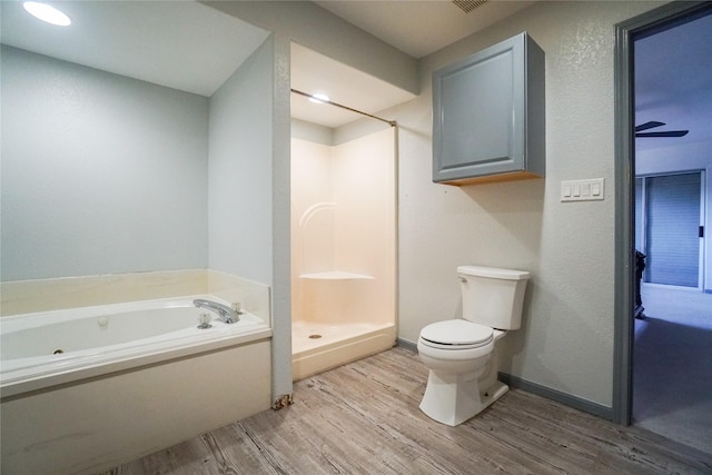 bathroom featuring hardwood / wood-style flooring, shower with separate bathtub, and toilet