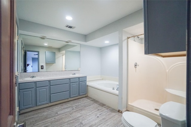 full bathroom with wood-type flooring, toilet, independent shower and bath, and vanity