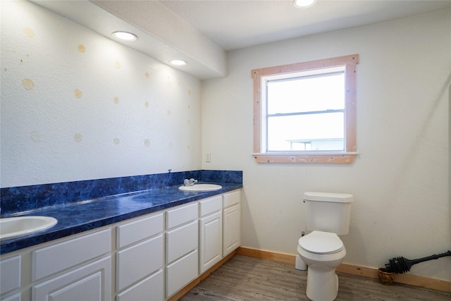 bathroom with vanity, toilet, and hardwood / wood-style floors