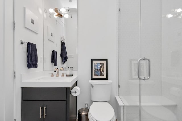 bathroom featuring walk in shower, vanity, and toilet