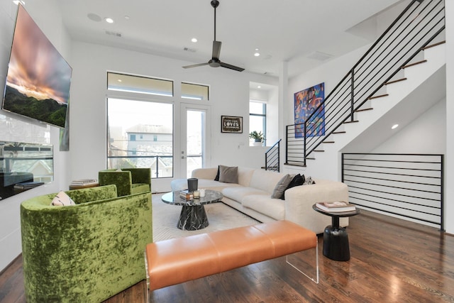 living room featuring ceiling fan and dark hardwood / wood-style flooring