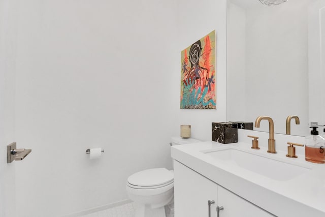 bathroom featuring vanity, tile patterned flooring, and toilet