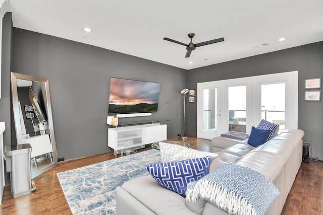 living room with wood-type flooring, ceiling fan, and french doors