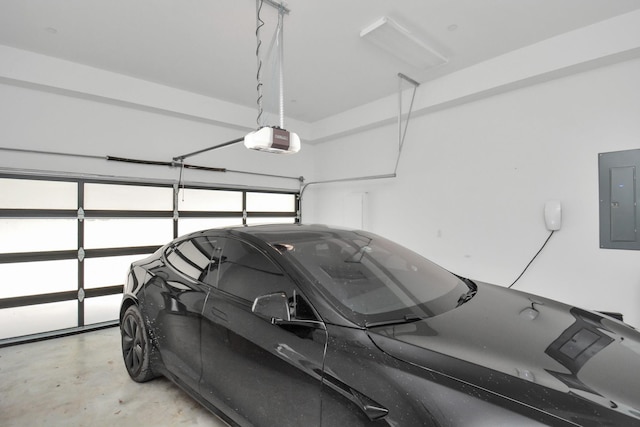 garage with a garage door opener and electric panel