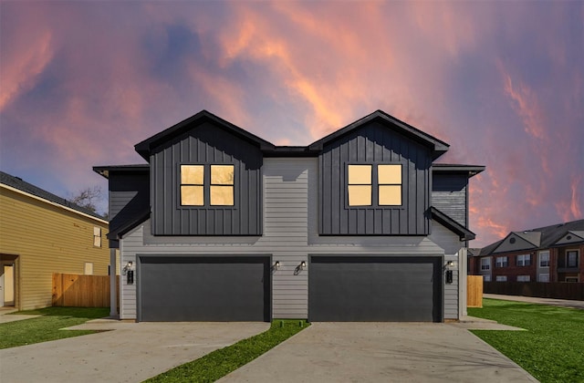 view of front of property with a garage and a lawn