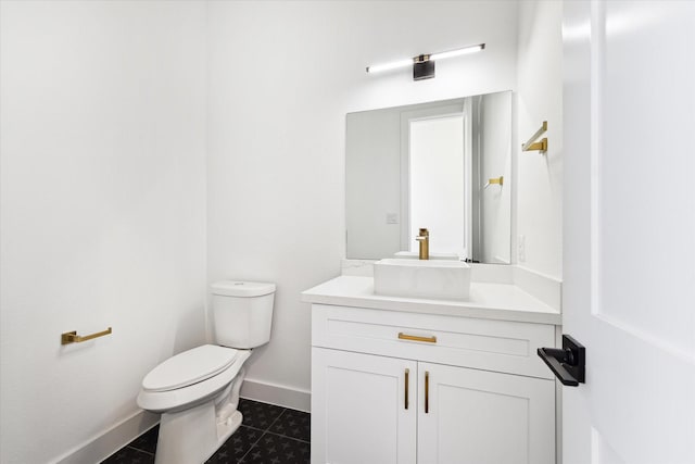 bathroom with vanity, toilet, and tile patterned flooring