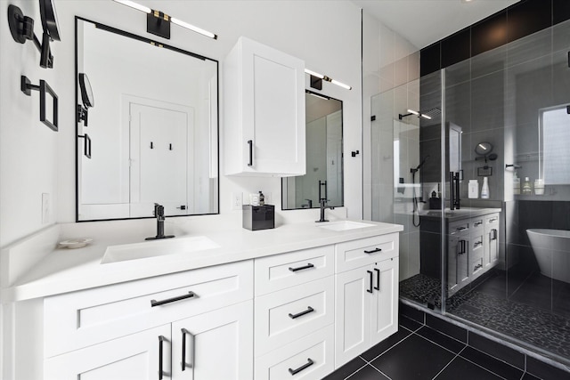 bathroom featuring a shower with door, vanity, and tile patterned floors