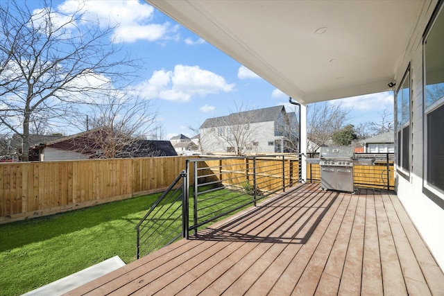 deck featuring area for grilling and a lawn