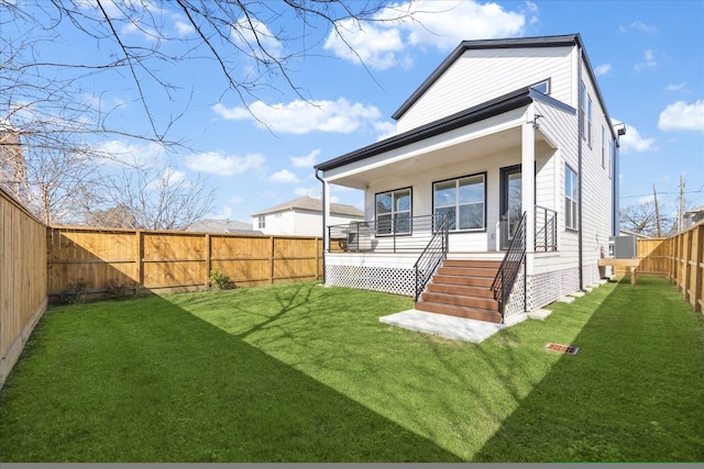 rear view of house featuring cooling unit and a yard