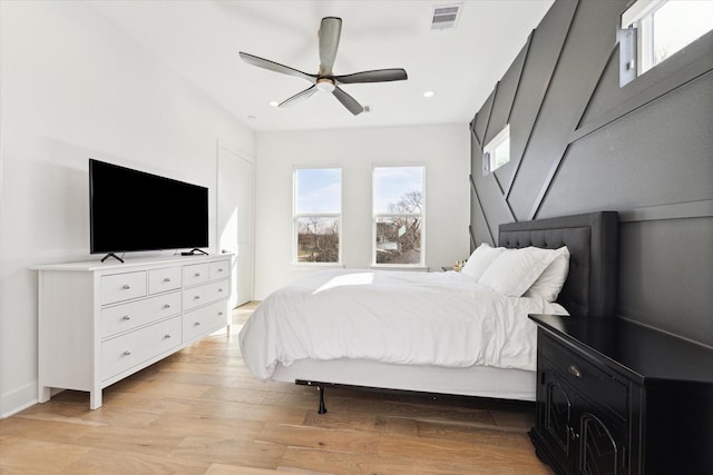 bedroom with light hardwood / wood-style flooring and ceiling fan