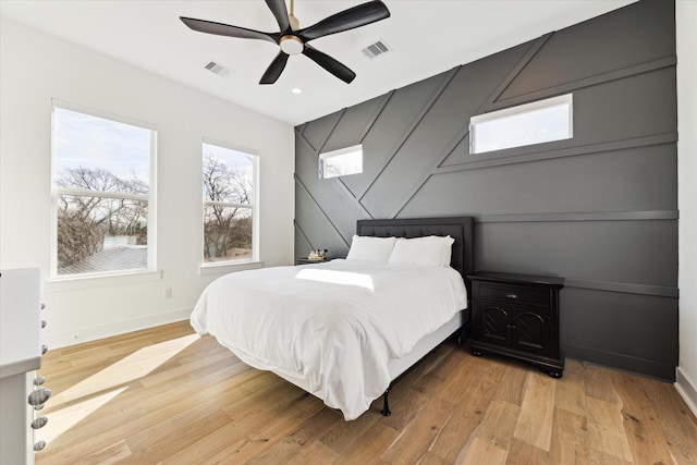 bedroom with ceiling fan and light hardwood / wood-style floors