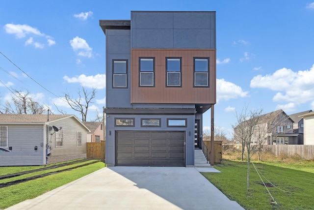 contemporary house featuring a garage and a front yard