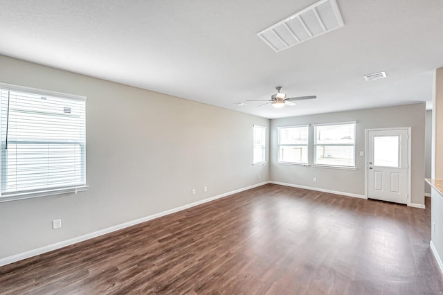 unfurnished room featuring dark hardwood / wood-style floors and ceiling fan