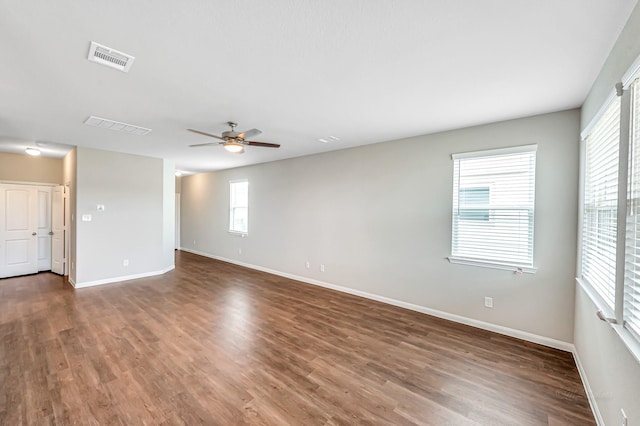 spare room featuring dark hardwood / wood-style flooring and ceiling fan