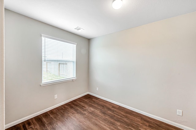 empty room featuring dark wood-type flooring