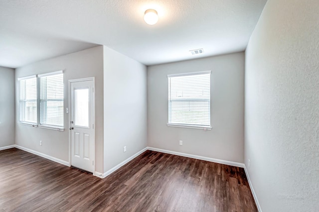 empty room featuring dark wood-type flooring