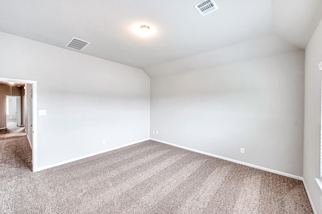 unfurnished room with vaulted ceiling and carpet floors