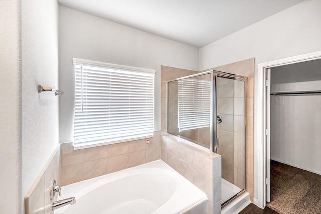 bathroom featuring separate shower and tub