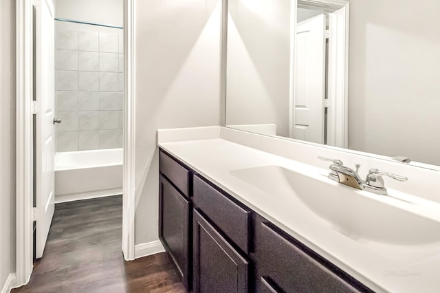 bathroom featuring vanity,  shower combination, and hardwood / wood-style floors