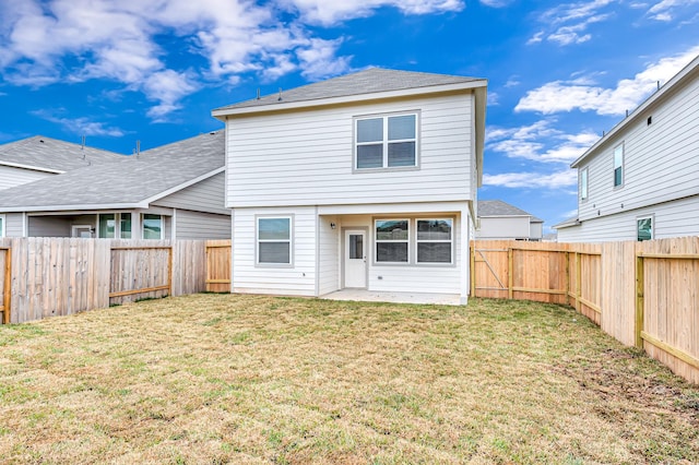 rear view of house with a yard and a patio area